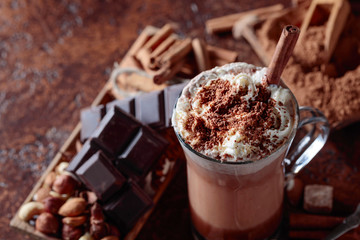 Cocoa with cream, cinnamon, chocolate pieces and various spices.