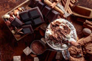 Cocoa with cream, cinnamon, chocolate pieces and various spices.