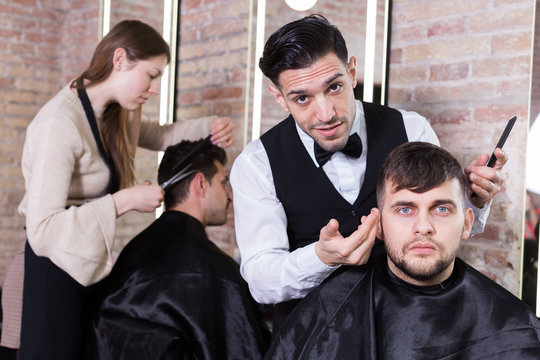 Hairdresser discussing preferences with male client