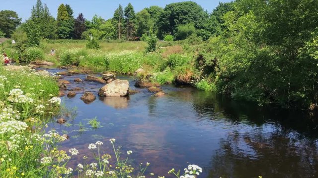 Pan from right to left of East Dart River near Postbridge in Dartmoor, UK