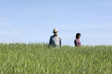 couple farmers on a wheat fileld