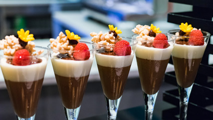 Delicious mousse or pudding in glasses with fresh raspberries, Maldives.
