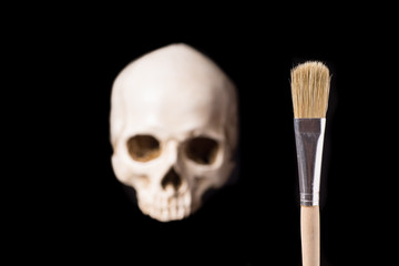Blurry white Skull and brush in front,