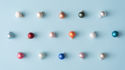 Minimal colorful Christmas baubles in pastel colors. Holiday concept. Flat lay.