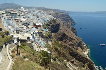 Fototapeta na wymiar Infinite Hillside Full Of Typical White And Blue Houses In The Beautiful City Of Fira On The Island Of Santorini. Architecture, landscapes, travel, cruises. July 7, 2018. Santorini, Thera. Greece.