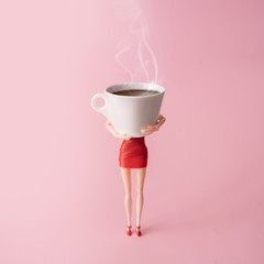 Girl in red dress holding big steaming cup of coffee against pastel pink background. Minimal coffee...