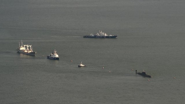 Top view of ships of Coast Guard of Frontier Directorate of Federal Security Service of Russia for Eastern Arctic Region and Russian submarine boat in Pacific Ocean. Avacha Bay, Kamchatka Peninsula.