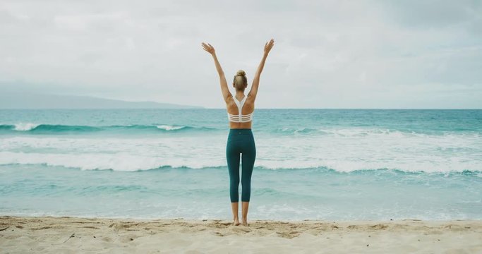 Fitness lifestyle of beautiful young woman stretching and practicing yoga at the beach - Powered by Adobe