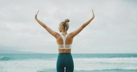 Fitness lifestyle of beautiful young woman stretching and practicing yoga at the beach - Powered by Adobe