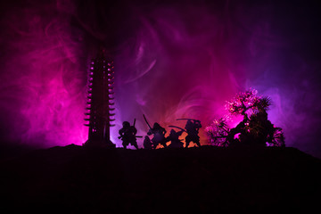 Samurai fighting concept. Silhouette of samurais in duel near tree and old temple. Picture with two...