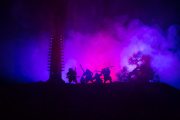 Samurai fighting concept. Silhouette of samurais in duel near tree and old temple. Picture with two...