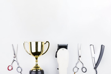 Golden trophy and scissors hairdresser set with various accessories isolated on white background with copy space for your message.Concept winner.