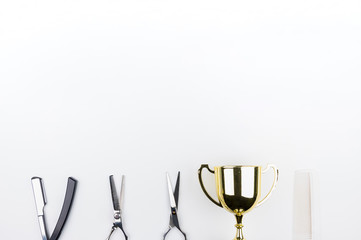 Golden trophy and scissors hairdresser set with various accessories isolated on white background with copy space for your message.Concept winner.