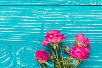Fototapeta na wymiar Blue wooden surface with beautiful roses