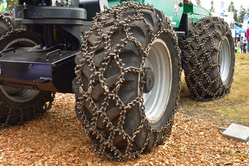 Fototapeta na wymiar Skidder chains or traction chains are put to tires for more effective traction to the ground when heavy equipments are at work.