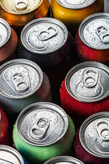 Cans of sweet drinks and beer. Cooling frozen and with water drops
