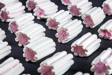 marshmallow pastel shades on black background.marshmallow Colorful pattern on pink pastel background and copy space