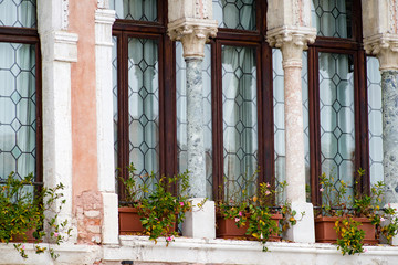 Fototapeta na wymiar Exterior details of palazzos & buildings in Venice, Italy as seen from the Grand Canal.