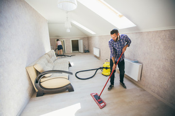 Young bearded man makes cleaning the house