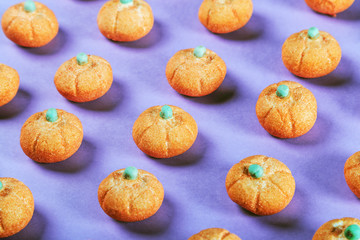 marshmallows in the shape of a pumpkin for the holiday Halloween on a purple background. pastel shade