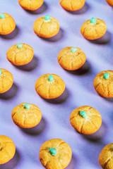 marshmallows in the shape of a pumpkin for the holiday Halloween on a purple background. pastel shade