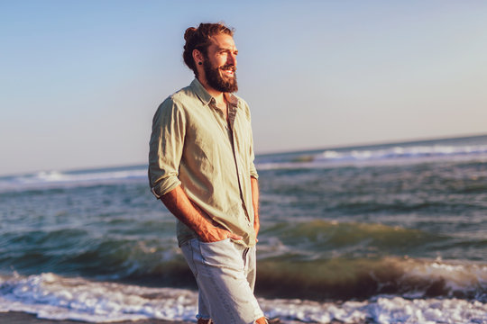 One man walking on the beach on sunset.