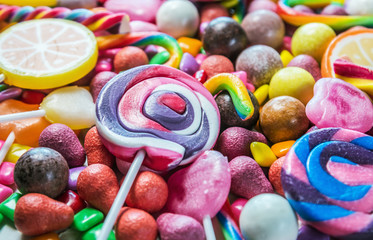 Fototapeta na wymiar background from variety of sweets, lollipops, chewing gum, candies, etc.