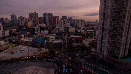 sunset over manila philippines colors skycraper main road