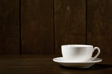 one classic coffee or tea cup on a dark wooden background