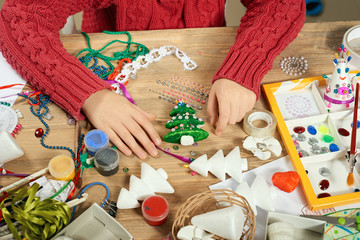 Childrens making decorations for new year holiday. Painting watercolors. Top view. Artwork workplace with creative accessories.