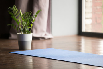 Yoga mat on the floor, blue carpet for practicing yoga in a sport studio, equipment for working out...