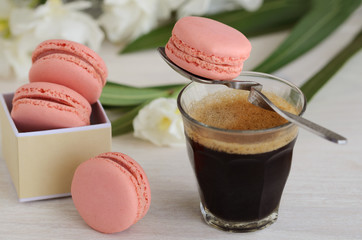 Black coffee espresso and pink macarons dessert. Good Morning concept.