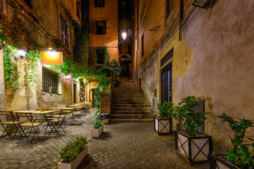 Fototapeta na wymiar Night view of old cozy street in Rome, Italy