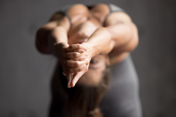 Young sporty woman practicing yoga, doing Ustrasana exercise, Camel pose, working out, wearing...