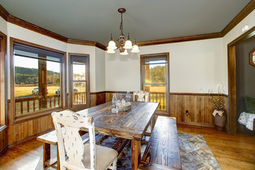 Traditional dining room accented with wood paneling.