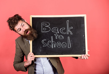 Take it easy. Teaching stressful occupation. Teacher with tousled hair stressful about school year beginning. Teacher bearded man holds blackboard with inscription back to school red background