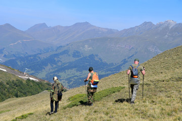Fototapeta na wymiar Russia, Caucasus, Arkhyz. Tourists on the plateau Gabulu in sunny weather