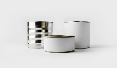 Three food tin cans with blank white labels. Responsive design mockup.