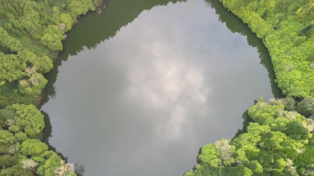 Lake in volcanic crater Lagoa do Congro, San Miguel Island, Azores, Portugal. Aerial shot. 4K, UHD