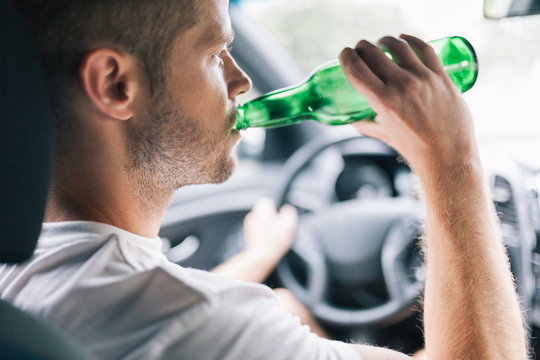 Drunk driver behind the steering wheel of a car