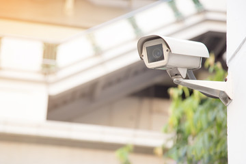 Security cctv camera or surveillance system on the white wall.