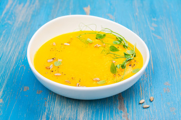 Pumpkin soup on blue wooden table