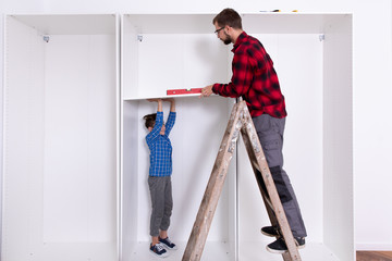 Young boys assembling  furniture at home

