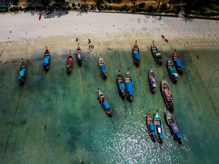 Several longtail boats at the Loh Dalum beach in Koh Phi Phi, Thailand - Drone photography