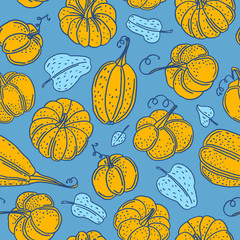 Hand drawn seamless vector pattern with orange pumpkins on the blue background. Seamless autumn ornament for fabric, wallpaper and wrapping paper. Autumn mood cute doodle illustration.