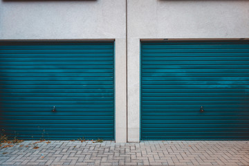 Fototapeta na wymiar green garage entrance door on white building