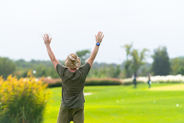 Adult holding his arms up to signal others