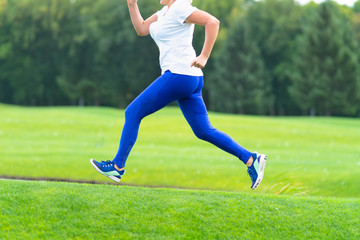 Naklejka premium Woman running across large open grassy field