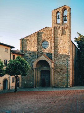 Local small church in Arezzo in Tuscany, photographed at sunset between the houses
