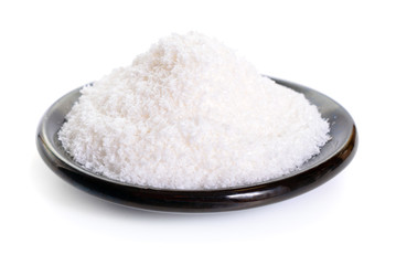 Plate with grated coconut isolated on white background